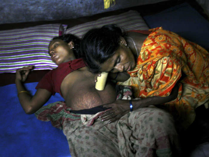 The midwife is trying to hear the heartbeat of the child with a plastic pipe. Bangladesh has a very high maternal mortality rate of 240 deaths per 100,000 live births. The reason behind this high death rate is that most of the births are delivered by untrained midwives.