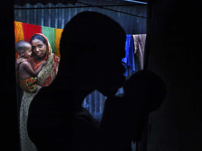 Even in the backdrop of grim poverty, the father welcomes the newborn with a kiss.