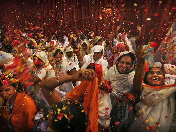 Indian widows throw flowers during Holi celebrations at the Meera Sahbhagini Ashram in Vrindavan.
