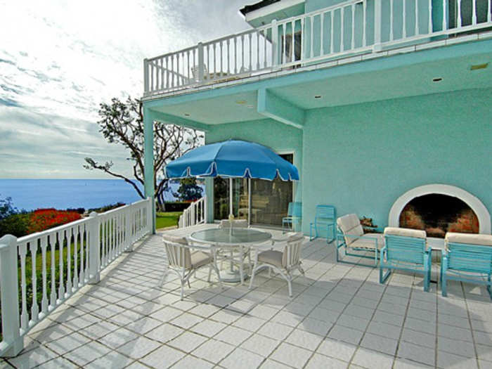 Outdoor porch area with a fireplace for those cool nights