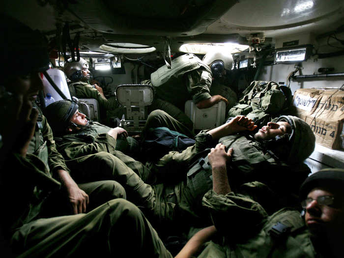 Israeli troops sleep in an armored personnel carrier (APC) during a military operation in the northern Gaza Strip July 7, 2006.