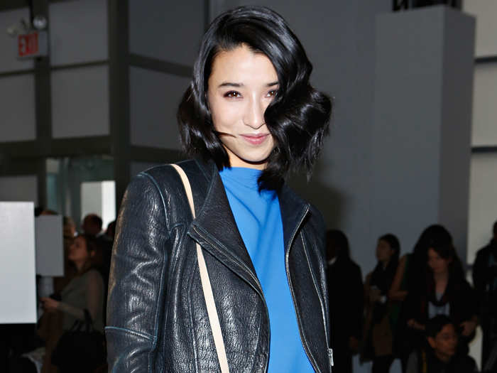 Fashionista Lily Kwan topped an elegant blue dress with an edgy leather jacket at the Reed Krakoff show during New York fashion week in Feb. 2013.