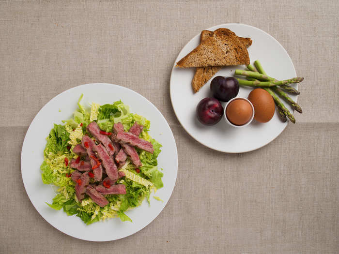 Here is an example of a 600-calorie meal: Breakfast is boiled eggs, asparagus spears, whole grain toast, and two plums. Dinner is Thai steak salad.