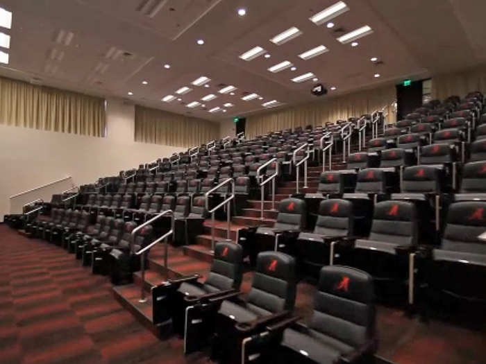 The main meeting room looks like a lecture hall, but with fancy leather chairs