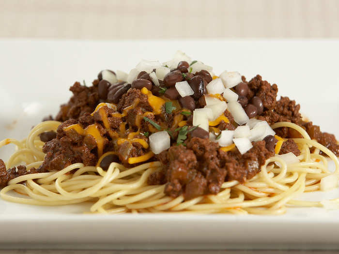 OHIO: Pop into a chili parlor for a plate of Cincinnati chili. The chili is spiced with cinnamon and cloves and spooned over spaghetti, then covered with kidney beans, diced onions, and grated cheddar cheese.