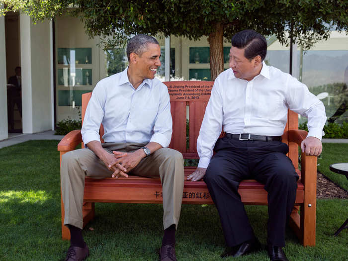 Obama presents President Xi Jinping with a gift of an inscribed redwood park bench.