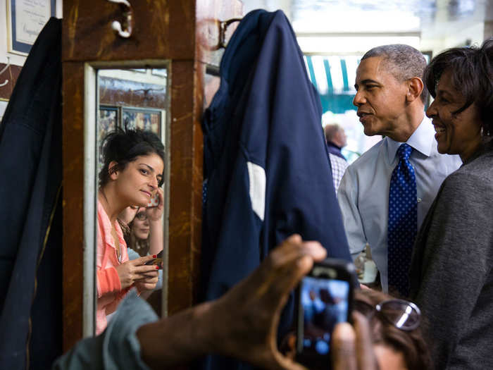 Obama greets patrons during an unannounced stop at Charlie