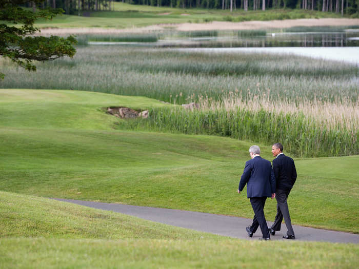 Obama walks with Prime Minister Stephen Harper of Canada on the grounds of Lough Erne Resort.