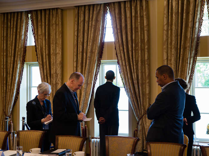 Obama waits with advisors before a bilateral meeting during the G8 Summit.