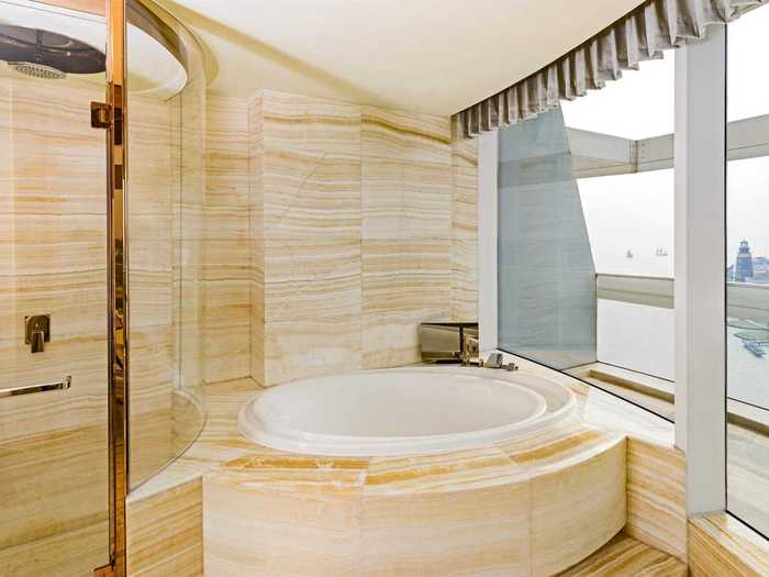 The spacious marble bathrooms have sunken bathtubs and walk-in rainforest showers.