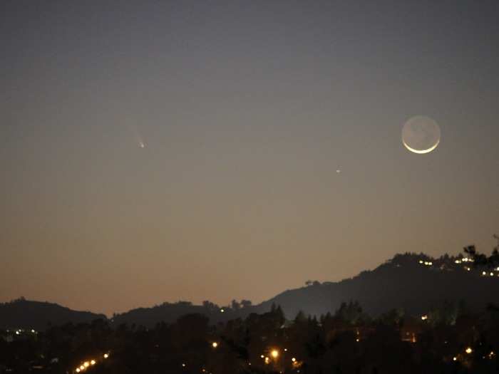 Here is the comet peeking through the smog above the mountains over Los Angeles. It was taken by astronomer Mike Brown.