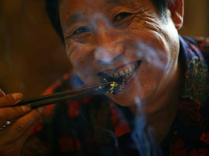 The end product: Hongchang enjoys a piece of snake meat at a restaurant in Zisiqiao.