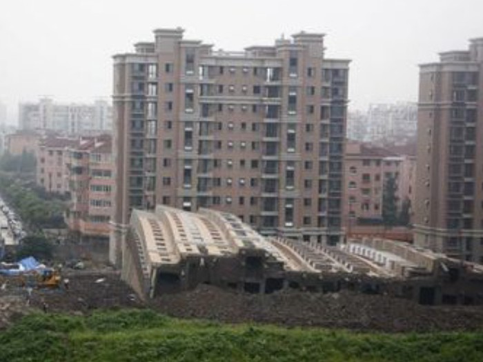 Buildings fall over sideways and are sometimes intact.