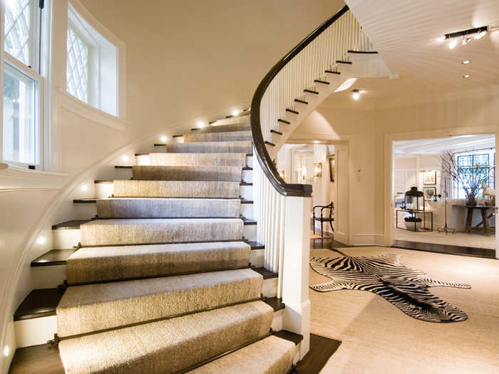 The sweeping spiral staircase leads to the upper stories of the home.