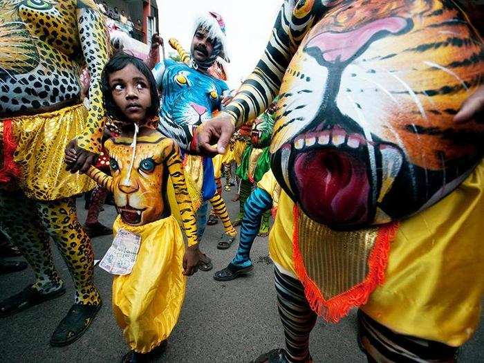 A young boy in Kerala, India, participates in the 200-year-old "tiger dance." Performers