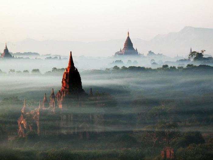 Beautiful buildings peek out from the mist in Bagan, Myanmar.