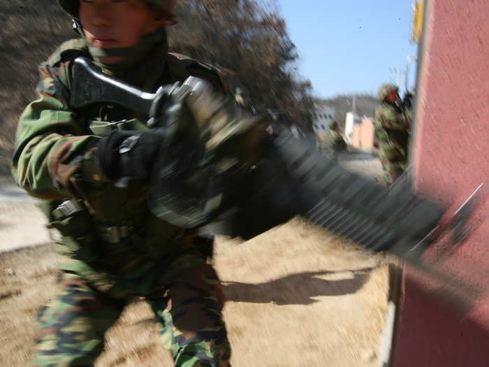 The Marines move in tandem, assaulting particular targets within the urban environment.