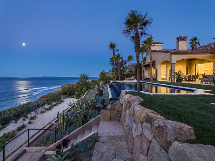 It has 130 feet of oceanfront property, and stairs leading down to the sand.