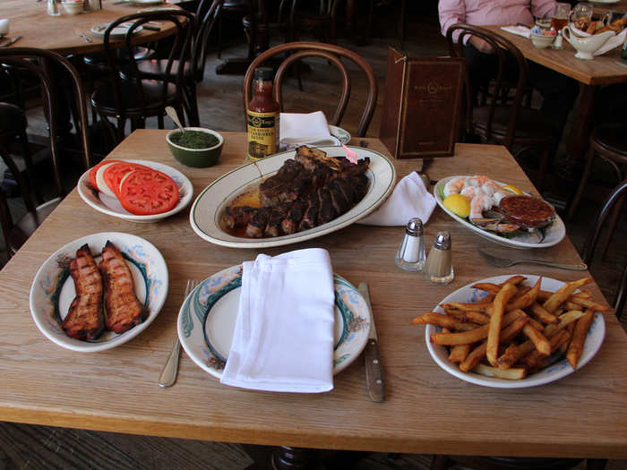 Jordan gets Danny to come work with him at a penny stock brokerage over steaks at Peter Luger.