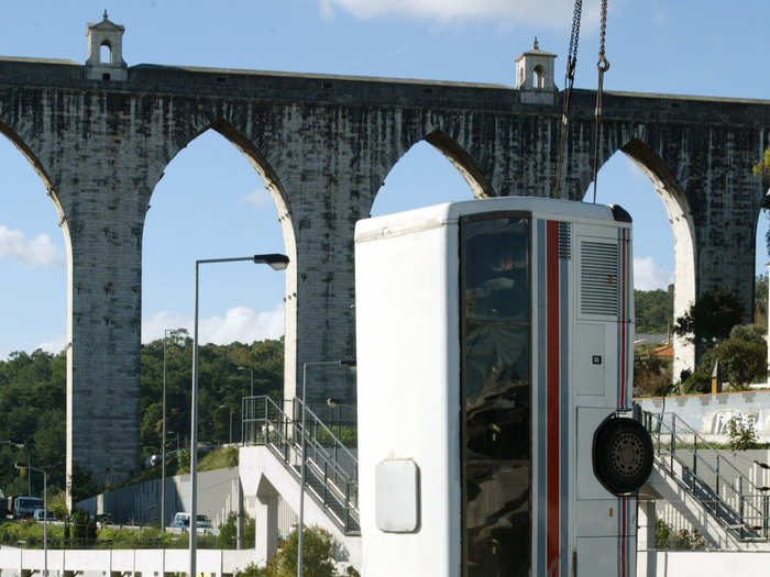 In November 2003 rescue workers had to remove this bus with a crane after it fell into a Lisbon, Portugal, street.