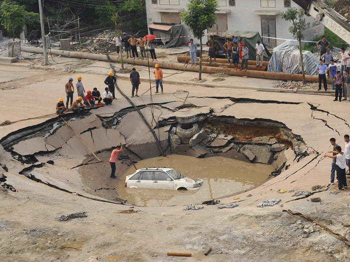 In September 2008 a road collapsed into a 16-foot deep, 50-foot wide hole and trapped a car in the Guangdong province of China.