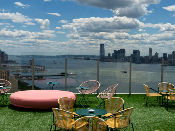 The glass-enclosed rooftop patio with green turf grass is another popular destination.