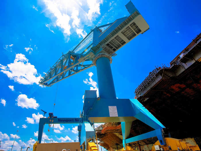 Using "Big Blue" — the largest crane in the Western Hemisphere — towering 235 feet above the shipyard.