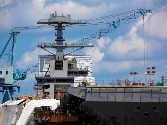 Moving the island house (the control tower) back further on the ship will accommodate an increased launch rate for the 75+ planes that will live aboard the carrier.