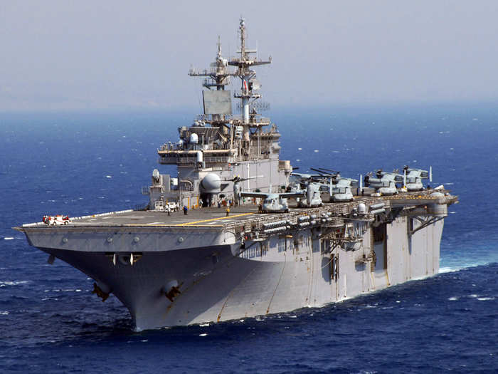 USS Wasp (LHD-1) is an amphibious assault ship that hosts Navy and Marine Corps aircraft and ferries troops overseas.