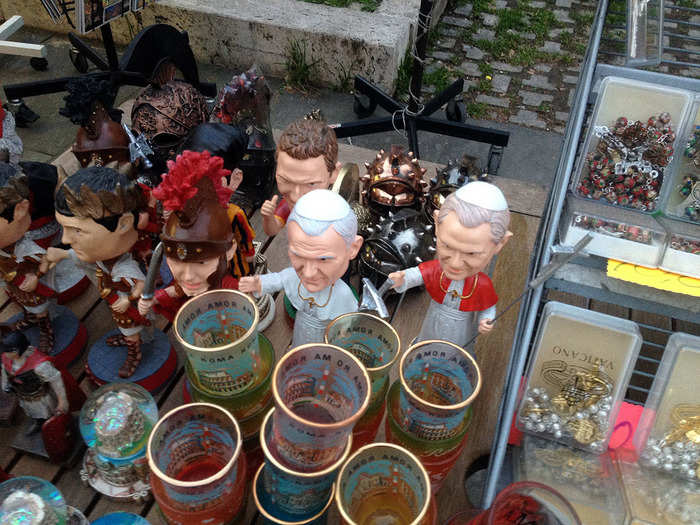 Stepping just outside the walls are lots of people selling gifts. Like these Pope bobbleheads.