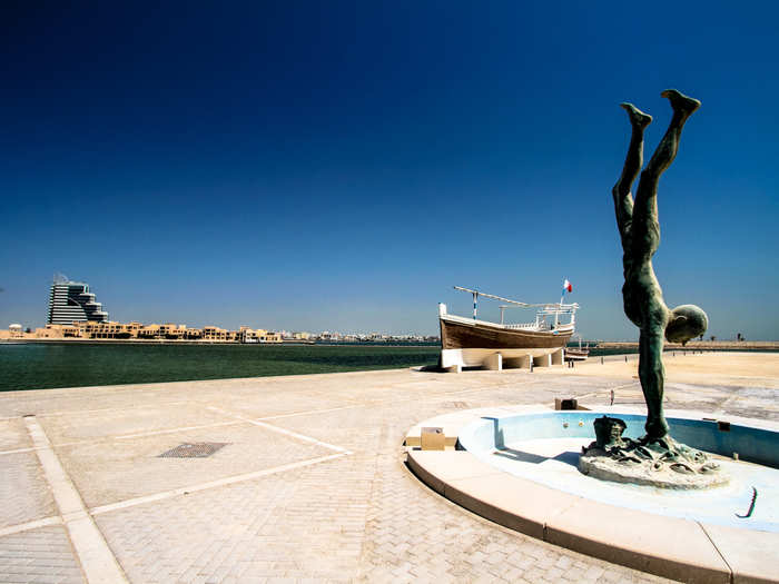 Behind the museum were fishing boats on blocks and this statue of a Bahraini pearl diver.