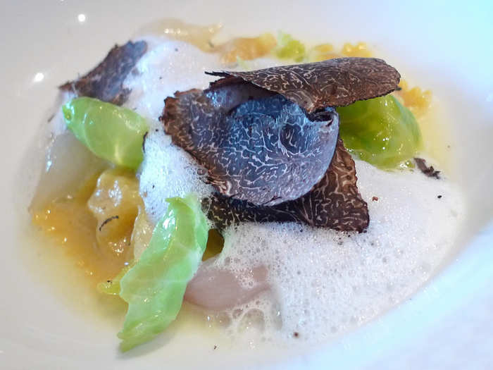 The hand-rolled parsnip agnolotti had pearl onions and was topped by huge black truffle shavings.