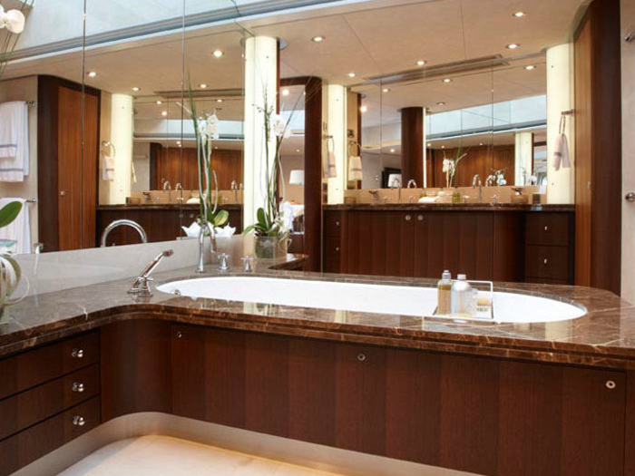 The master bath includes a large tub, and some lovely plant life.