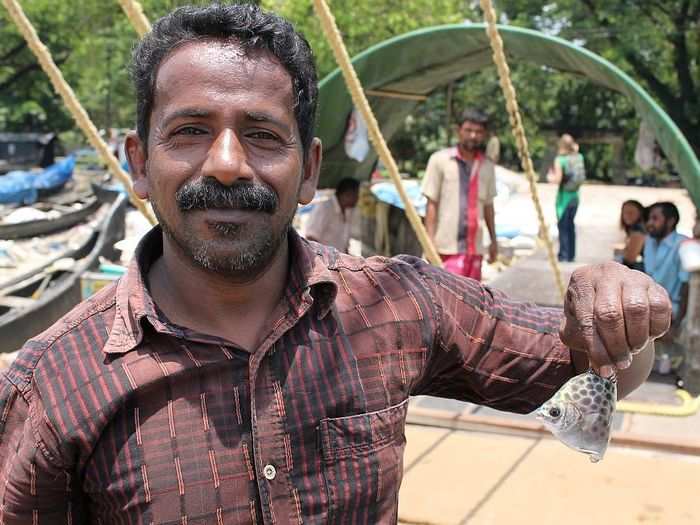 They were also struck by how hard it was to make a living by fishing along the streams. Here, a villager poses with a tiny fish he caught.