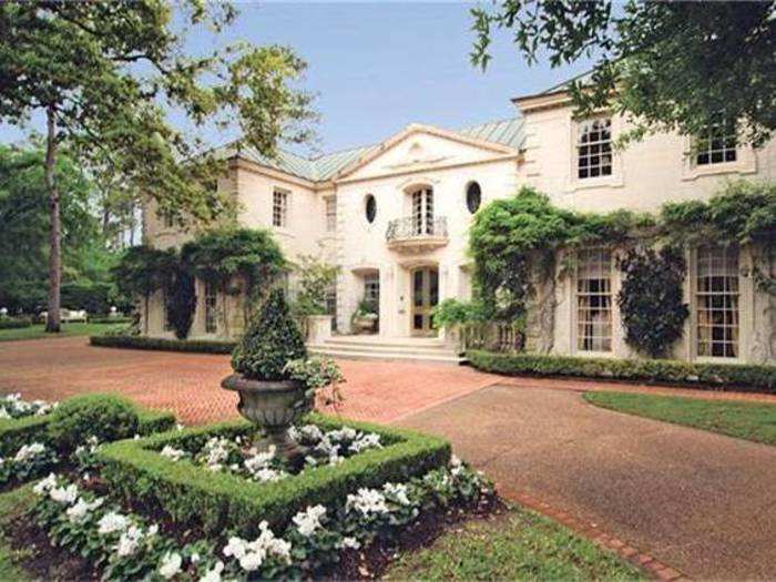 This chateau in Houston, Texas has a walnut-paneled library.