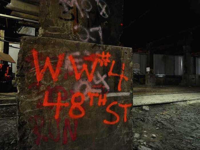 Underground, fluorescent graffiti provides some direction in a rare color photo from Suzuki.