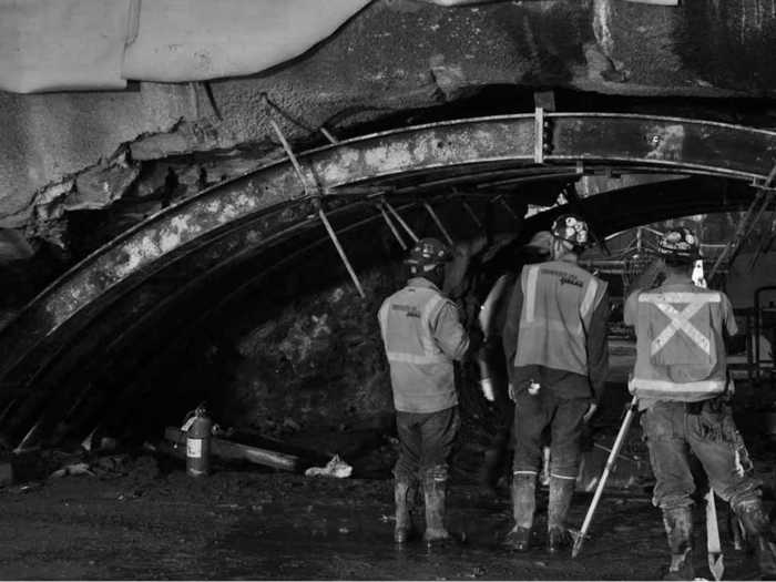 Three men survey the scene.