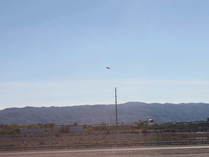 We guessed the blimp in the sky was there for the Waste Management Phoenix Open, a golf tournament.