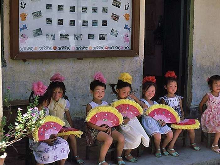 These girls sat and posed for photos. As I remember, they sat here throughout our visit.