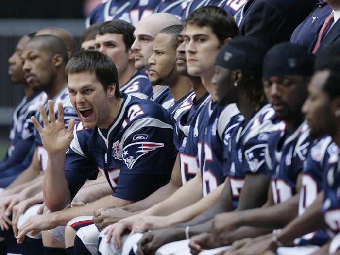 Tom Brady goofs around during a team photo in 2007