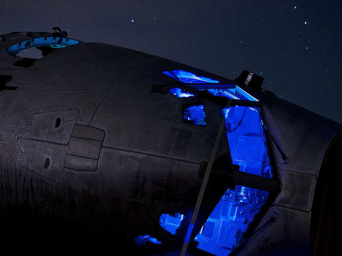 The cockpit section of a C-141 Starlifter sits dissected and strapped to the ground.