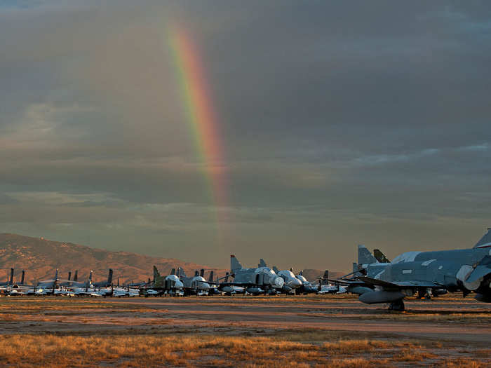 A rainbow peaks at the old unused fleet of F-4 Phantom fighters.