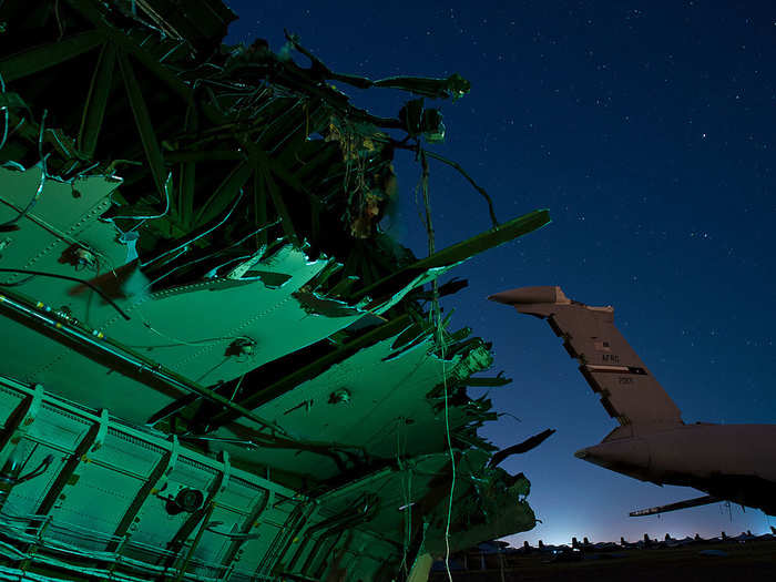 Ripped and torn pieces of the fuselage are all that remain of a C-5 Galaxy after being torn apart by an excavator crane for scrap.