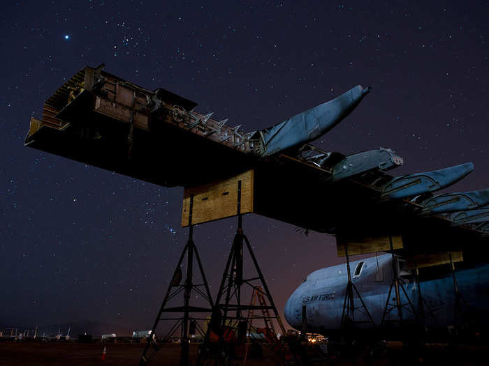 A C-5 Galaxy, its wings stripped to the frame, is undergoing a complete tear-down of all important parts before being demolished for scrap, a process that takes nearly a year to complete.