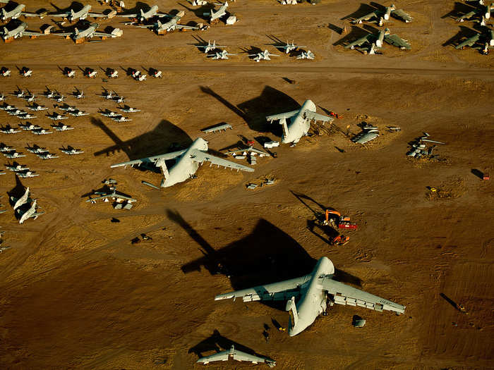 Wings and parts are pulled from the C-5 Galaxy aircraft before the airframes are torn apart for scrap.