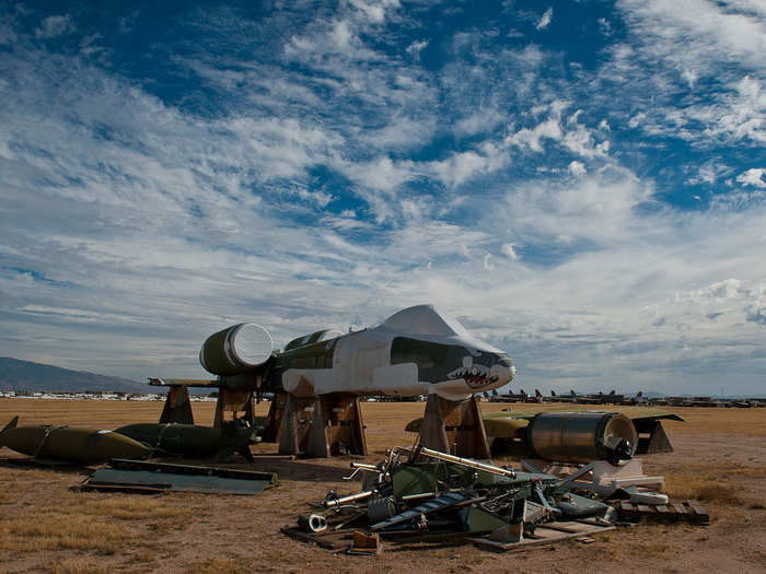 The fuselage of an A-10 Thunderbolt II sits surrounded by the rest of its parts. Aircraft like this are typically used to provide parts to other A-10s still serving throughout the Air Force.