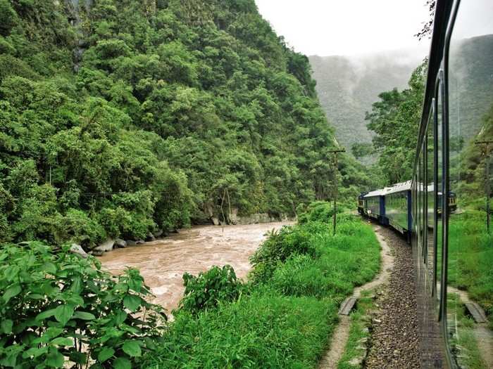 The train route traverses the Sacred Valley of the Incas along the Urubamba River, passing ancient ruins and fortresses.