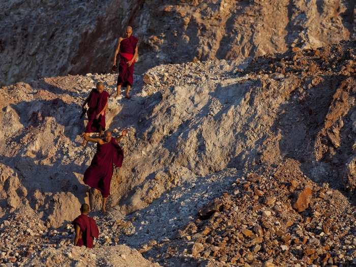 Monks are seen walking around in Letpadaung mine.