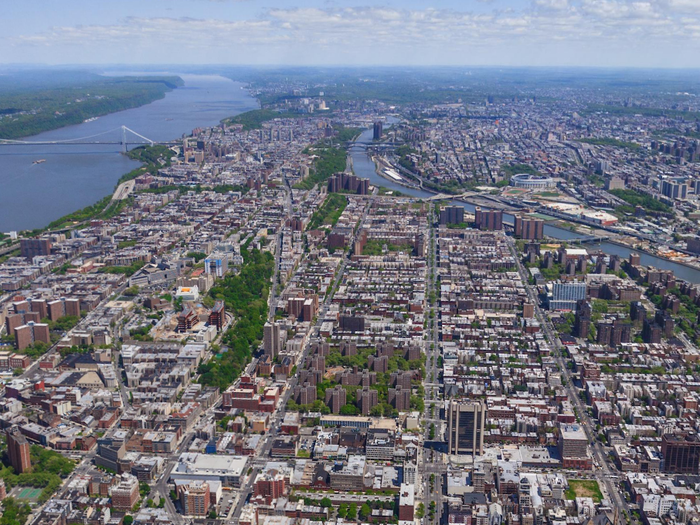 A rare view of Upper Manhattan, including Harlem, Washington Heights, and Inwood. To the left, the George Washington Bridge; to the right, the Bronx.