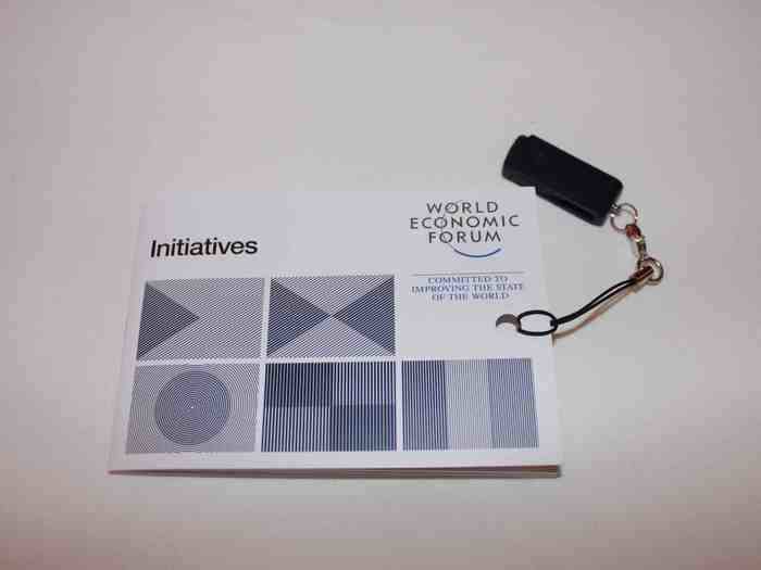 A brochure of "initiatives," with an attached thumb-drive.